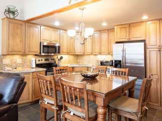 This stunning kitchen features beautiful wooden cabinetry, offering ample storage and a warm, inviting atmosphere.