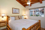 This cozy bedroom features a rustic wooden bed frame, creating a warm and inviting atmosphere.