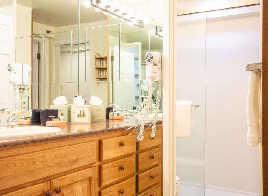 Step into a well-appointed bathroom featuring a vanity with ample storage and a stylish countertop.