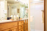 Step into a well-appointed bathroom featuring a vanity with ample storage and a stylish countertop.