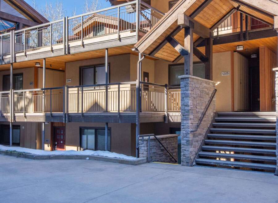 Discover the charm of this multi-level property, featuring a blend of rustic wood and stone accents.