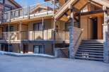 Discover the charm of this multi-level property, featuring a blend of rustic wood and stone accents.