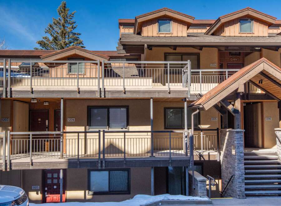 Discover a charming multi-unit property with a rustic exterior and inviting balconies.