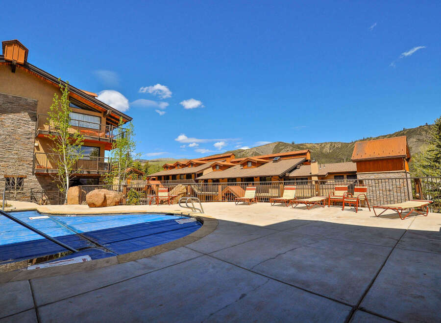 Discover a luxurious retreat with this stunning property featuring a beautiful outdoor pool and ample lounging space.