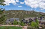Discover this stunning mountain resort property, featuring a charming village atmosphere with modern architecture nestled against a dramatic natural landscape.