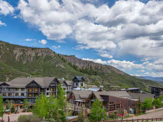 Discover luxury mountain living in this stunning property nestled against a dramatic mountain backdrop.