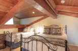 Discover this charming attic bedroom featuring two comfortable beds, perfect for accommodating guests.