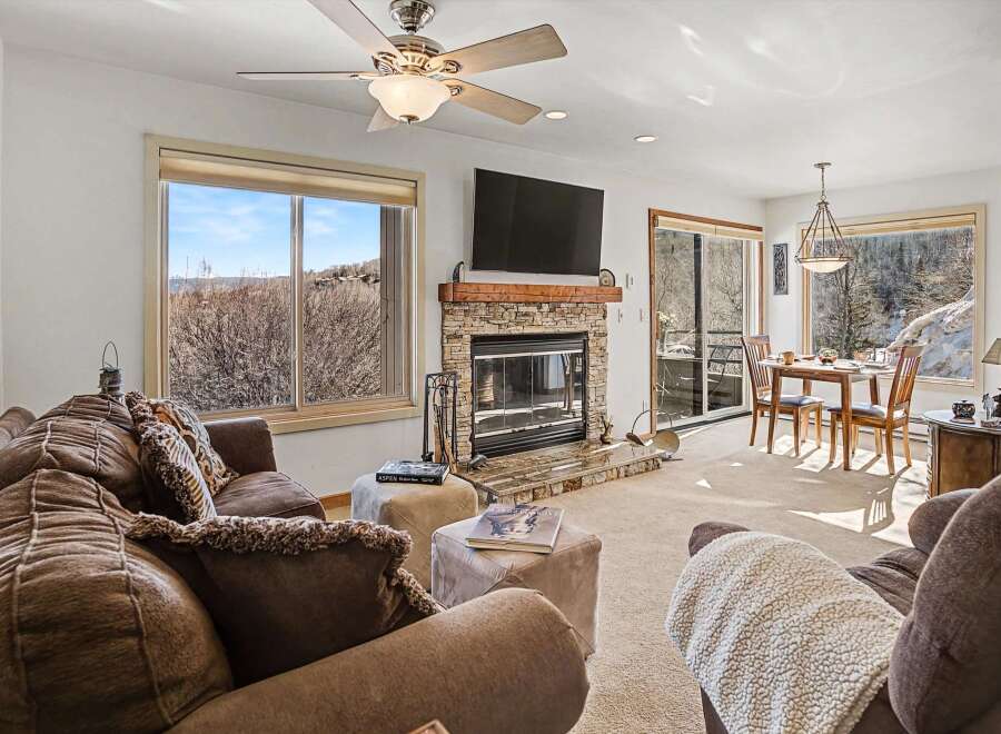 Experience the warmth of this inviting living space, featuring a cozy fireplace and ample natural light.