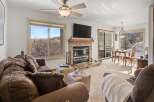 Experience the warmth of this inviting living space, featuring a cozy fireplace and ample natural light.