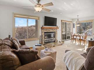 Experience the warmth of this inviting living space, featuring a cozy fireplace and ample natural light.