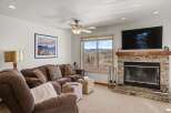 This stunning living room boasts a cozy fireplace and a large TV, perfect for relaxing evenings.