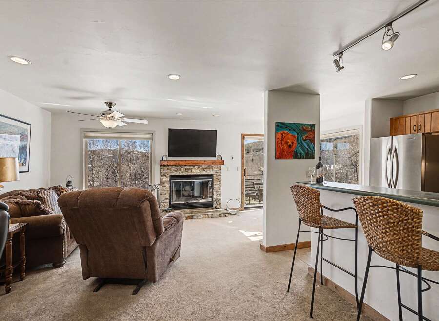 This stunning property boasts a cozy living room with a fireplace, perfect for relaxing evenings.