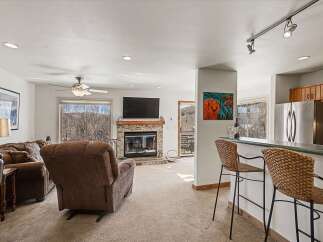 This stunning property boasts a cozy living room with a fireplace, perfect for relaxing evenings.