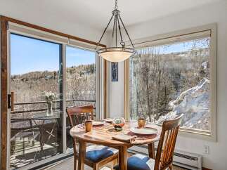 Enjoy breathtaking mountain views from this charming dining area.