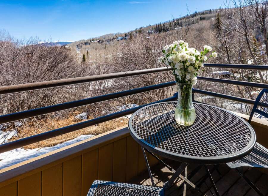 Enjoy breathtaking mountain views from this charming balcony.