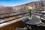 Enjoy breathtaking mountain views from this charming balcony.