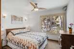 This inviting bedroom features a comfortable bed with stylish bedding, perfect for a relaxing retreat.
