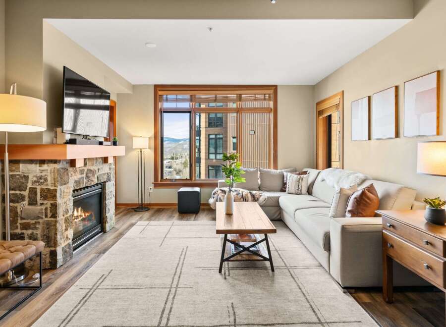 Experience luxury living in this stunning property featuring a cozy fireplace and a spacious, modern living area.