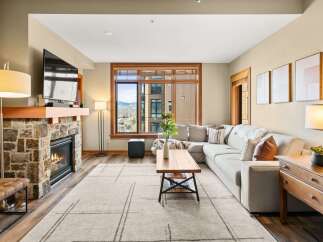 Experience luxury living in this stunning property featuring a cozy fireplace and a spacious, modern living area.