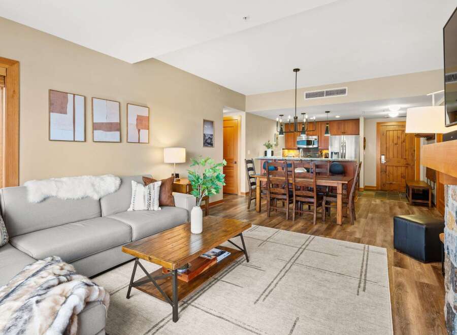 This stunning property boasts a spacious living area with a cozy fireplace, perfect for relaxing evenings.