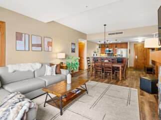 This stunning property boasts a spacious living area with a cozy fireplace, perfect for relaxing evenings.