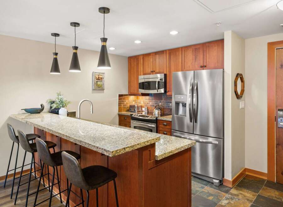 This stunning kitchen boasts modern appliances and a stylish breakfast bar, perfect for entertaining.
