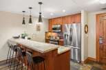 This stunning kitchen boasts modern appliances and a stylish breakfast bar, perfect for entertaining.
