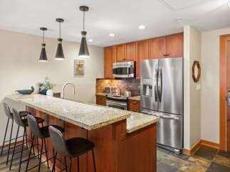 This stunning kitchen boasts modern appliances and a stylish breakfast bar, perfect for entertaining.