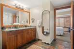 This luxurious bathroom features a double vanity with a granite countertop and ample storage.