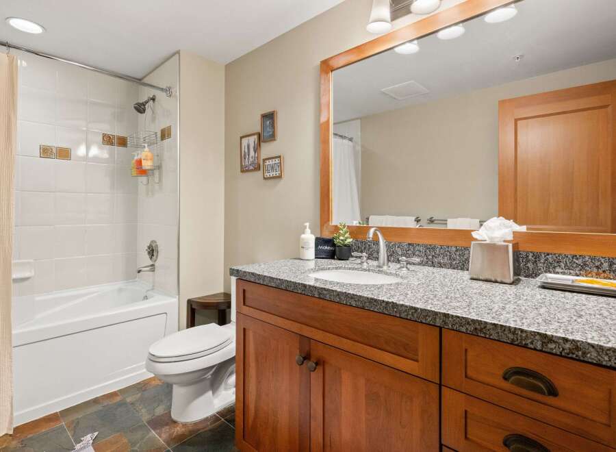 This stunning bathroom boasts a modern design with a touch of rustic charm.