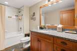 This stunning bathroom boasts a modern design with a touch of rustic charm.