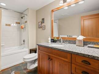 This stunning bathroom boasts a modern design with a touch of rustic charm.