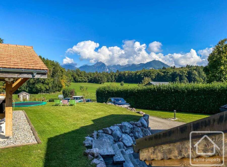 Discover the charm of this stunning property, boasting a lush green lawn and breathtaking mountain views.