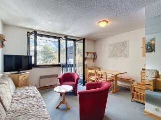 Discover a cozy living space with stunning views! This charming property features a comfortable sofa, two inviting armchairs, and a dining area perfect for gatherings.