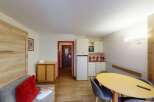 Discover this charming apartment featuring a well-equipped kitchenette, perfect for preparing meals.