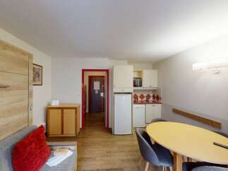 Discover this charming apartment featuring a well-equipped kitchenette, perfect for preparing meals.