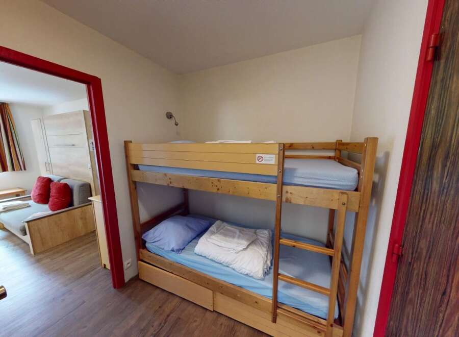 This cozy room features a bunk bed, perfect for accommodating guests or family members.