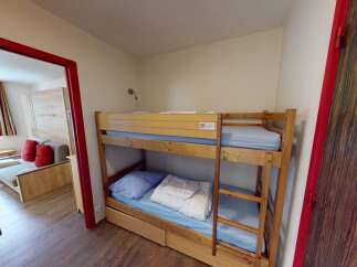 This cozy room features a bunk bed, perfect for accommodating guests or family members.