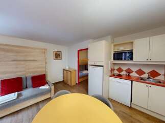Discover this cozy apartment featuring a well-equipped kitchen with modern appliances.
