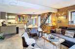 Discover the charm of this stunning property, featuring a cozy living space with a modern kitchen and a dining area.