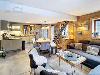 Discover the charm of this stunning property, featuring a cozy living space with a modern kitchen and a dining area.
