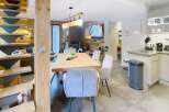 This stunning property features a modern kitchen with sleek cabinetry and a cozy dining area perfect for entertaining.