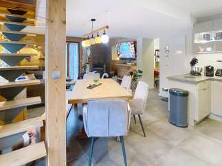 This stunning property features a modern kitchen with sleek cabinetry and a cozy dining area perfect for entertaining.