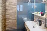 This modern bathroom features a sleek design with a glass shower enclosure and a stylish vanity.