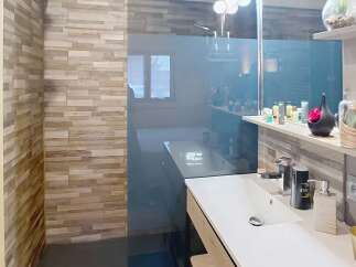 This modern bathroom features a sleek design with a glass shower enclosure and a stylish vanity.