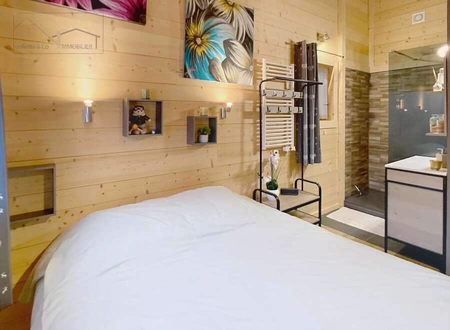 This cozy bedroom features a warm wooden interior, creating a relaxing atmosphere.