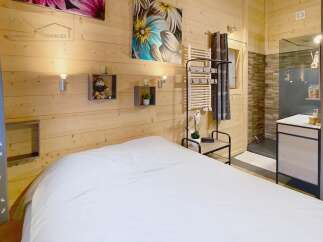 This cozy bedroom features a warm wooden interior, creating a relaxing atmosphere.