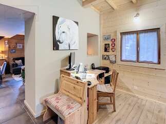 This charming property features a cozy workspace with a desk and bench, perfect for remote work or creative projects.