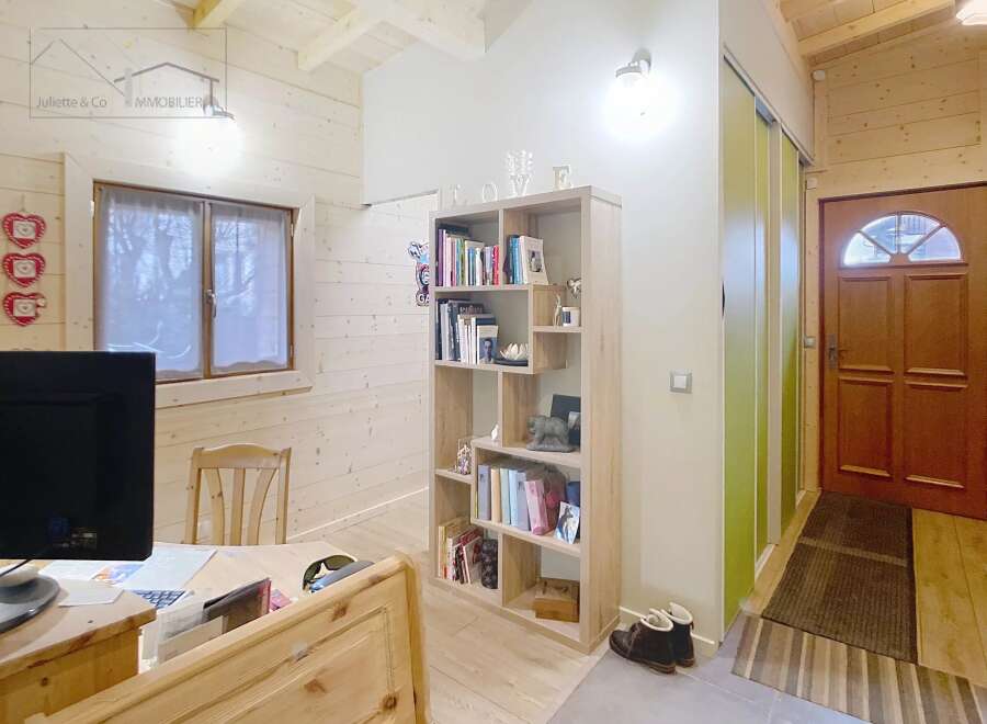 This charming property features a cozy interior with wooden accents, creating a warm and inviting atmosphere.