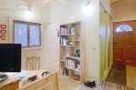 This charming property features a cozy interior with wooden accents, creating a warm and inviting atmosphere.